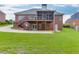 Expansive backyard featuring a screened deck, patio, and lush green lawn, perfect for outdoor entertaining at 995 Lewis Ridge Cir, Lawrenceville, GA 30045