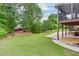 Lush backyard with a view of the screened deck, patio and mature trees offering shade and privacy at 995 Lewis Ridge Cir, Lawrenceville, GA 30045