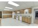 Basement kitchen with tile flooring, light wood cabinets, and lots of counter space at 995 Lewis Ridge Cir, Lawrenceville, GA 30045
