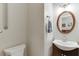 Half bath features a modern vanity, wood trimmed mirror, lighting, and fixtures at 995 Lewis Ridge Cir, Lawrenceville, GA 30045