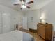 A cozy bedroom features wood floors, a ceiling fan, a closet, and neutral walls at 995 Lewis Ridge Cir, Lawrenceville, GA 30045