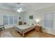 Spacious bedroom with natural light, hardwood floors, tray ceilings, and a ceiling fan at 995 Lewis Ridge Cir, Lawrenceville, GA 30045