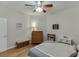 Neutral bedroom with wood floors, ceiling fan, queen bed, and lots of natural light at 995 Lewis Ridge Cir, Lawrenceville, GA 30045