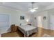 Comfortable bedroom with hardwood floors, tray ceilings, and an ensuite bathroom at 995 Lewis Ridge Cir, Lawrenceville, GA 30045