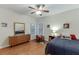 A comfy bedroom features wood floors, neutral walls, a ceiling fan, and lots of natural light at 995 Lewis Ridge Cir, Lawrenceville, GA 30045