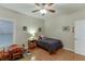 Bedroom boasts lots of natural light, wood floors, a ceiling fan, and neutral walls at 995 Lewis Ridge Cir, Lawrenceville, GA 30045