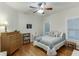 This cozy bedroom features hardwood floors, a ceiling fan, and a comfortable bed at 995 Lewis Ridge Cir, Lawrenceville, GA 30045
