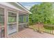 Spacious wooden deck with view to sunroom and a view of the yard at 995 Lewis Ridge Cir, Lawrenceville, GA 30045