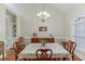 Elegant dining room featuring a chandelier, table set for dinner, and built in shelving at 995 Lewis Ridge Cir, Lawrenceville, GA 30045