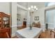 Traditional dining room with hardwood floors, chandelier, and view to entry foyer at 995 Lewis Ridge Cir, Lawrenceville, GA 30045