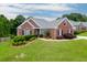 Charming single-story brick home with manicured landscaping, lush green lawn and beautiful curb appeal at 995 Lewis Ridge Cir, Lawrenceville, GA 30045