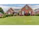 Traditional red brick home with black shutters and green lawn, showcasing classic design at 995 Lewis Ridge Cir, Lawrenceville, GA 30045