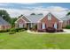 Attractive single-story brick home with a well-kept lawn, complemented by mature shrubs and trees at 995 Lewis Ridge Cir, Lawrenceville, GA 30045
