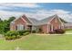 Charming brick home with manicured lawn, complemented by verdant shrubbery and mulch beds at 995 Lewis Ridge Cir, Lawrenceville, GA 30045