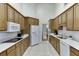 Functional kitchen with white countertops, oak cabinets, and modern appliances at 995 Lewis Ridge Cir, Lawrenceville, GA 30045