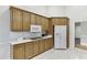 Well-lit kitchen features oak cabinets, white appliances, and a white tile backsplash at 995 Lewis Ridge Cir, Lawrenceville, GA 30045