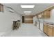 Spacious kitchen with tile floors, wooden cabinets, and white appliances in finished basement at 995 Lewis Ridge Cir, Lawrenceville, GA 30045