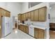 Efficient kitchen featuring white countertops, oak cabinets, and stainless steel sink at 995 Lewis Ridge Cir, Lawrenceville, GA 30045
