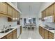 Bright kitchen with tile floors, oak cabinets, stainless sink, and an adjacent dining area at 995 Lewis Ridge Cir, Lawrenceville, GA 30045