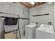 Laundry room features modern washer and dryer units with unfinished walls at 995 Lewis Ridge Cir, Lawrenceville, GA 30045