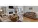 Charming living room featuring a fireplace, hardwood floors, and a comfortable seating area at 995 Lewis Ridge Cir, Lawrenceville, GA 30045