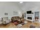 Inviting living room featuring high ceilings, fireplace, and comfortable seating arrangement at 995 Lewis Ridge Cir, Lawrenceville, GA 30045
