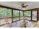 Relaxing sunroom with wicker furniture overlooking a beautiful backyard at 995 Lewis Ridge Cir, Lawrenceville, GA 30045