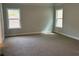 Spacious bedroom with plush carpeting and natural light from two windows at 5311 Tuscany Dr, Douglasville, GA 30135