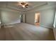 A spacious bedroom with neutral carpet, tray ceiling, and a ceiling fan for added comfort at 5311 Tuscany Dr, Douglasville, GA 30135