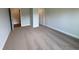 Bedroom showing neutral colored carpet and paint with 2 entry doors at 5311 Tuscany Dr, Douglasville, GA 30135