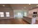 Open kitchen featuring granite counters, stainless appliances, an island, and hardwood floors at 5311 Tuscany Dr, Douglasville, GA 30135