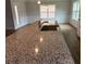 Close-up of kitchen island with granite countertops and a sink at 5311 Tuscany Dr, Douglasville, GA 30135
