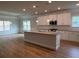 Open kitchen featuring granite counters, stainless appliances, an island, and hardwood floors at 5311 Tuscany Dr, Douglasville, GA 30135