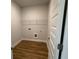 Small laundry room with a single wire shelf above washer-dryer connections at 5311 Tuscany Dr, Douglasville, GA 30135