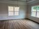 Open living room featuring white trim, large windows, and hard surface floors at 5311 Tuscany Dr, Douglasville, GA 30135