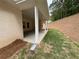 View of the covered patio highlighting the concrete flooring and landscaping at 5311 Tuscany Dr, Douglasville, GA 30135