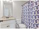 Bathroom with granite countertop vanity and blue patterned shower curtain at 125 Atkins Ln, Fayetteville, GA 30215