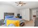 Cozy bedroom with ceiling fan, wood headboard, and view into hallway at 125 Atkins Ln, Fayetteville, GA 30215