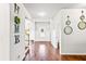 Open foyer with hardwood floors, decorative mirrors, and a view of the main entry door at 125 Atkins Ln, Fayetteville, GA 30215