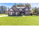 Beautiful two-story home featuring a well-manicured lawn and complementary brick and siding accents at 125 Atkins Ln, Fayetteville, GA 30215