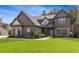 Charming two-story home with beautiful exterior, manicured lawn, and inviting curb appeal at 125 Atkins Ln, Fayetteville, GA 30215
