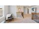 Bright hallway featuring an iron lantern pendant light, chair, staircase, and natural light from the large window at 125 Atkins Ln, Fayetteville, GA 30215