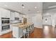 Bright, open-concept kitchen with granite countertops, island seating, stainless appliances, and hardwood flooring at 125 Atkins Ln, Fayetteville, GA 30215