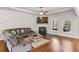 Cozy living room featuring a fireplace, hardwood floors, and a comfortable sectional sofa at 125 Atkins Ln, Fayetteville, GA 30215