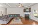Spacious living room features a fireplace, hardwood floors, and a large sectional sofa at 125 Atkins Ln, Fayetteville, GA 30215