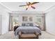Cozy main bedroom features a tray ceiling, stylish decor, and a comfortable king-size bed with coordinating bedside tables at 125 Atkins Ln, Fayetteville, GA 30215