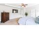 Spacious main bedroom with ceiling fan, TV, and neutral color palette at 125 Atkins Ln, Fayetteville, GA 30215
