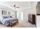 Charming main bedroom with decorative wall art, king size bed, ceiling fan, and comfortable bench at 125 Atkins Ln, Fayetteville, GA 30215