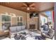 Covered outdoor patio features a fireplace, ceiling fan, and comfortable seating at 125 Atkins Ln, Fayetteville, GA 30215