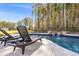 Inviting pool with lounge chairs and waterfall feature surrounded by lush trees at 125 Atkins Ln, Fayetteville, GA 30215